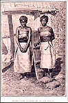 Two fashionable Tanosy women from southeastern Madagascar wearing plaited-reed dresses and brassieres and wide leather belts